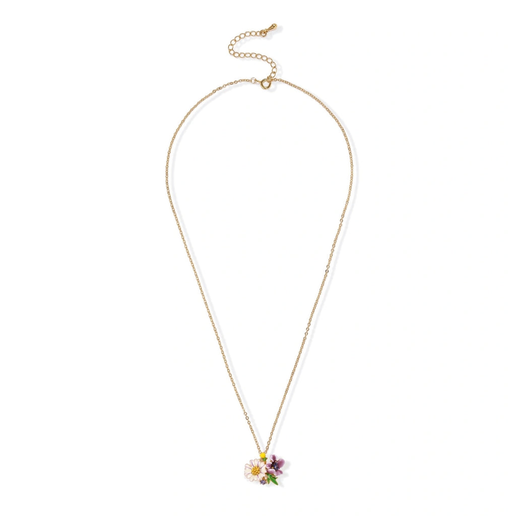 Gold-plated necklace with pink and purple enamel flower pendant featuring crystal accents on cream background