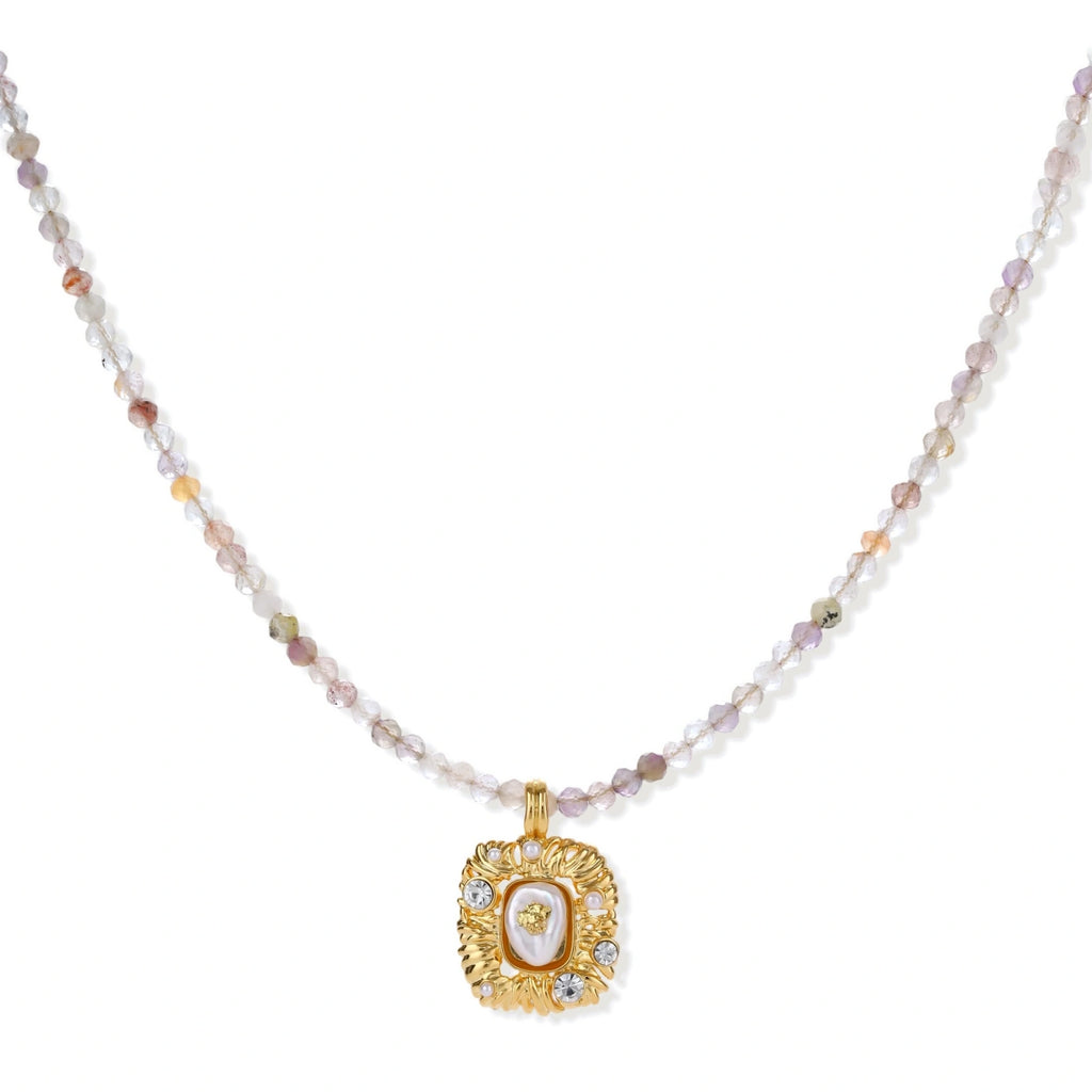 Ornate gold-plated pendant necklace with multicolored gemstone beads in purple, pink and clear tones on white background