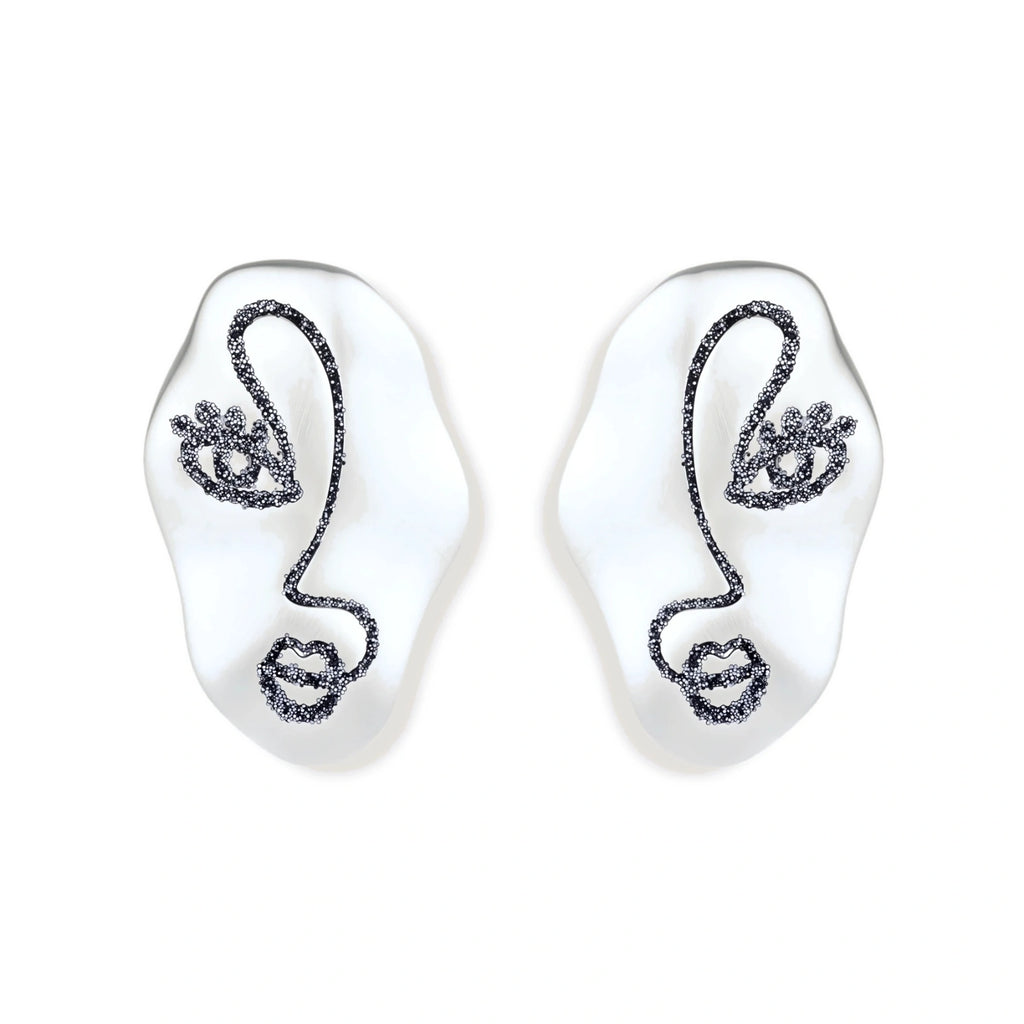 Artistic ear-shaped earrings with minimalist face line art on clear eco-zinc alloy base with sterling silver posts.