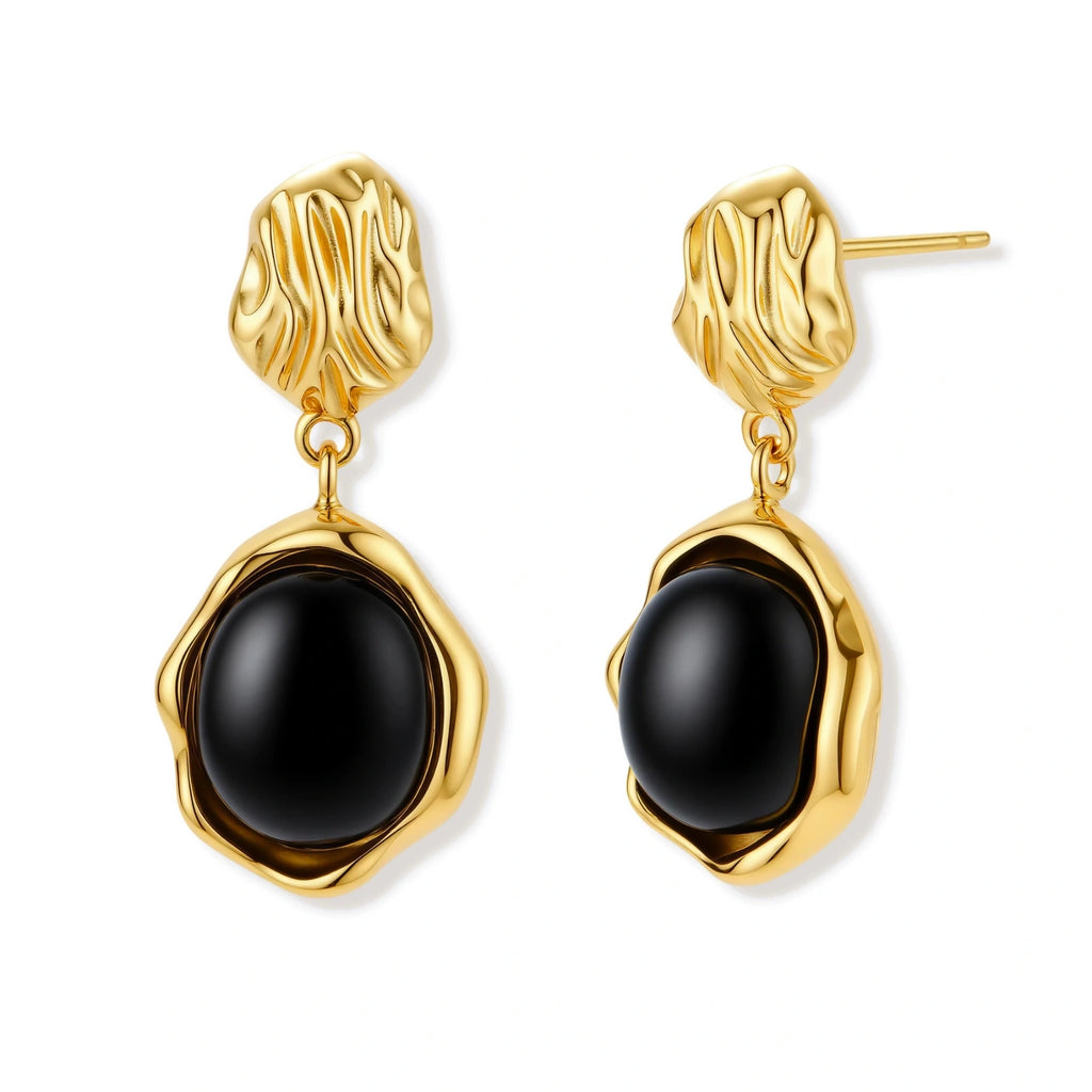 Gold-plated rippled stud earrings with black agate stone drops on white background