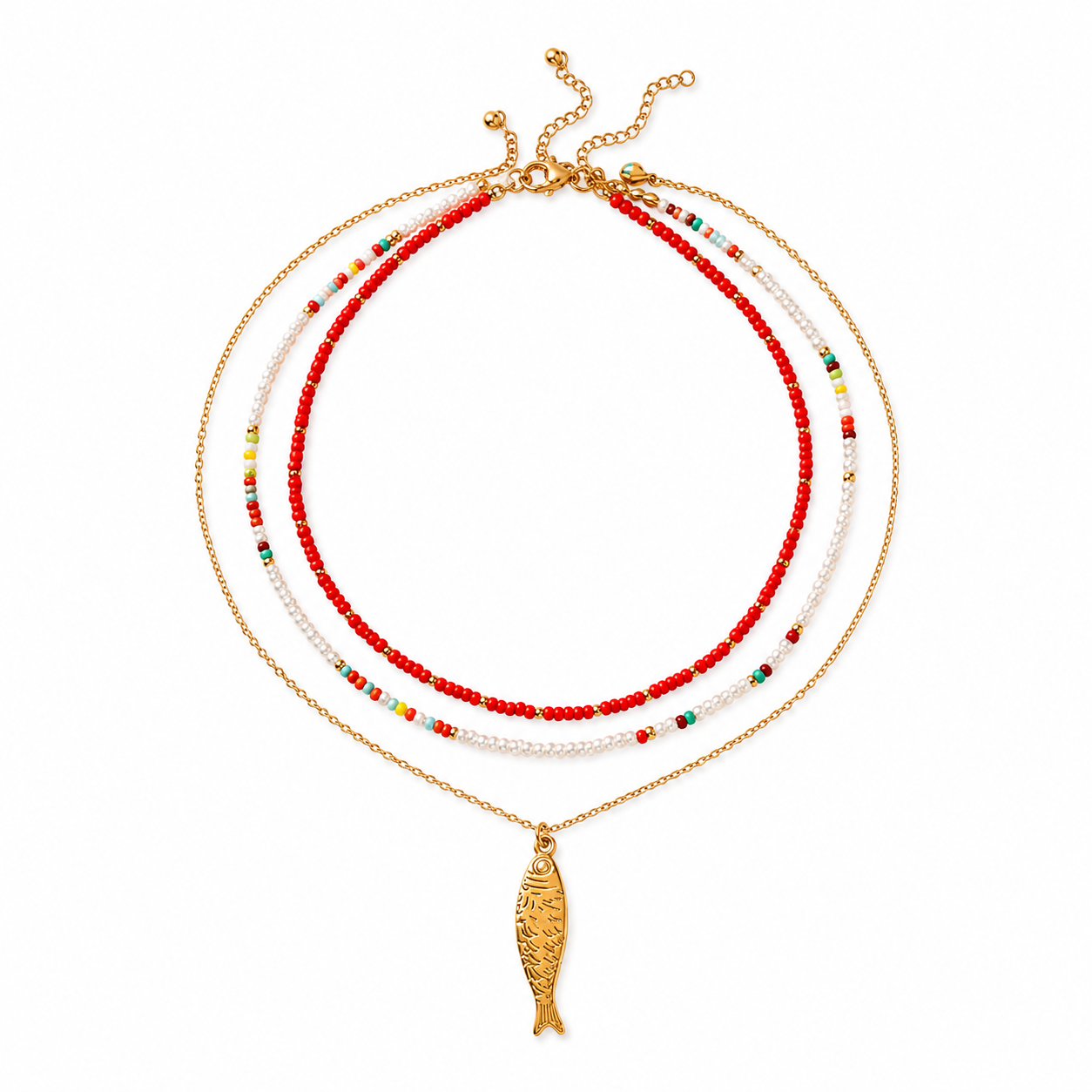 A gold-tone layered necklace featuring three beaded strands in red, white, and multicolor accents, with a dangling fish-shaped pendant, shown on a plain white background.
