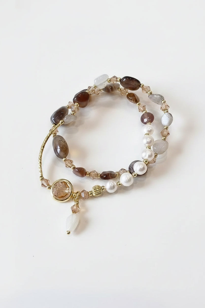 Beaded bracelet with gold accents on a textured surface