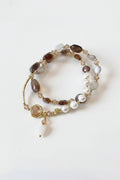 Beaded bracelet with gold accents on a textured surface