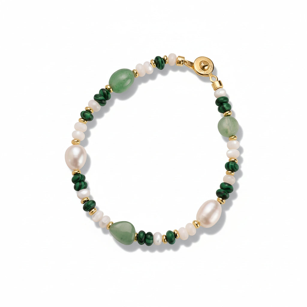 Beaded bracelet with green and white pearls on a beige background