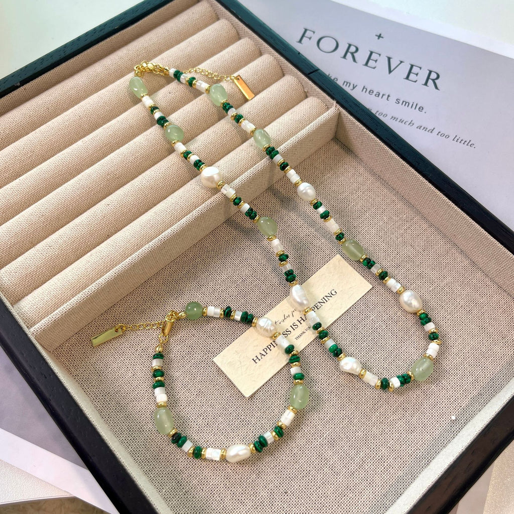 Beaded necklace and bracelet set in a jewelry box with 'Forever' text.