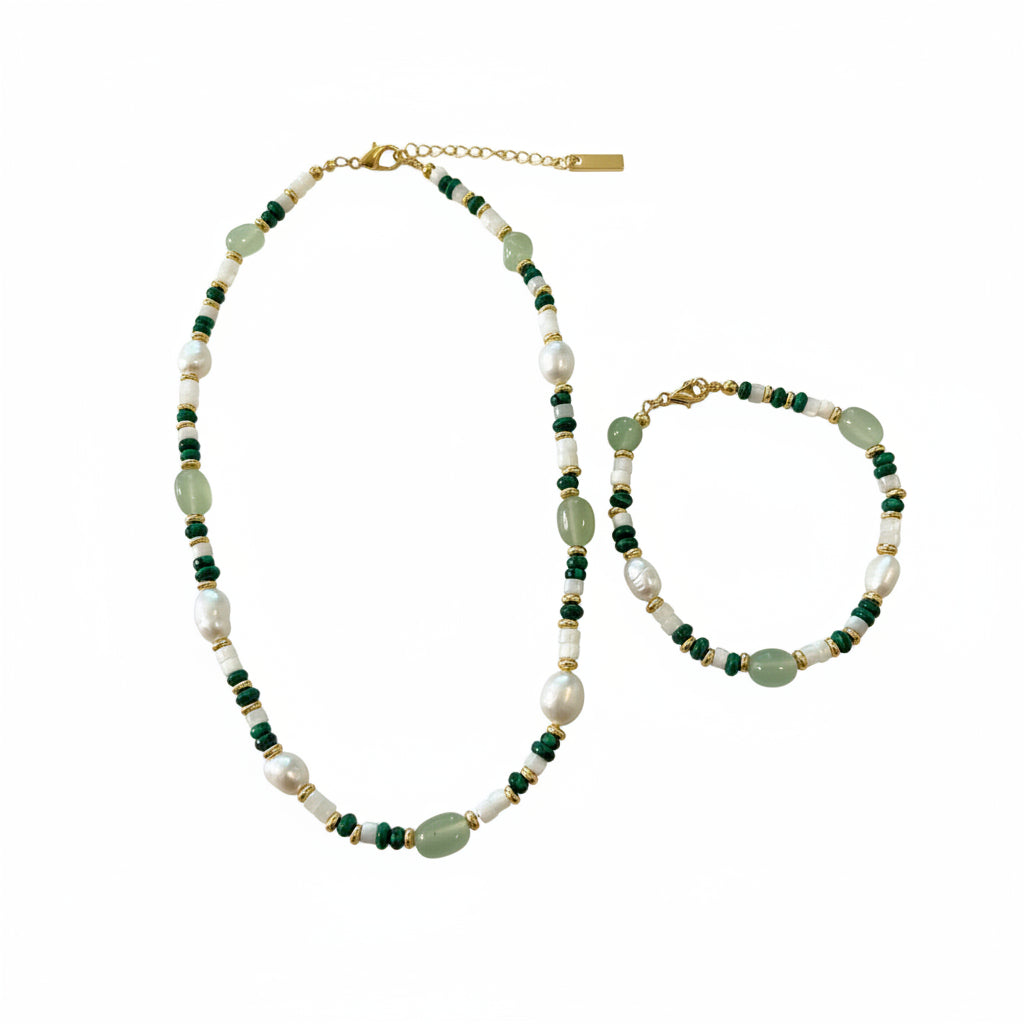Beaded necklace with green and white stones on a textured surface