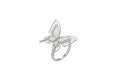 Butterfly-shaped ring on a person's finger with a neutral background