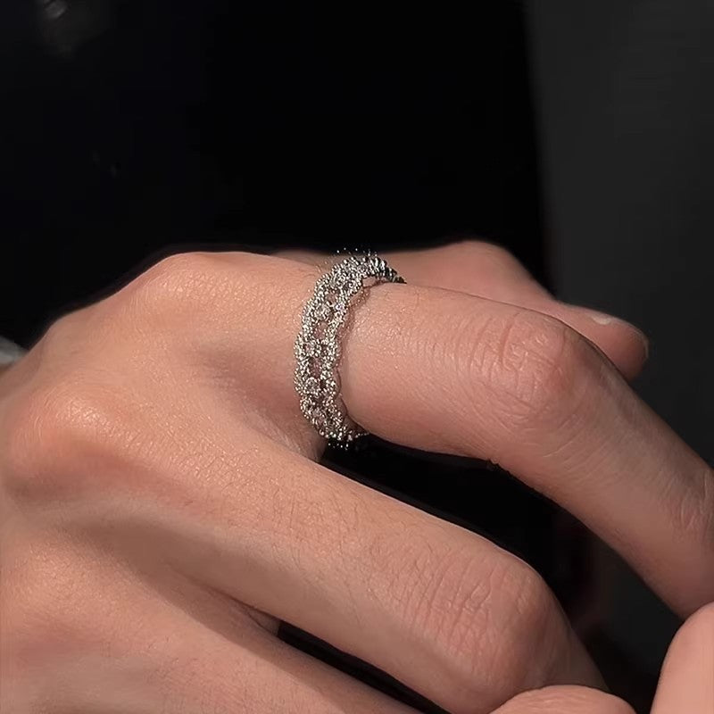 Close-up of a hand wearing a silver ring 