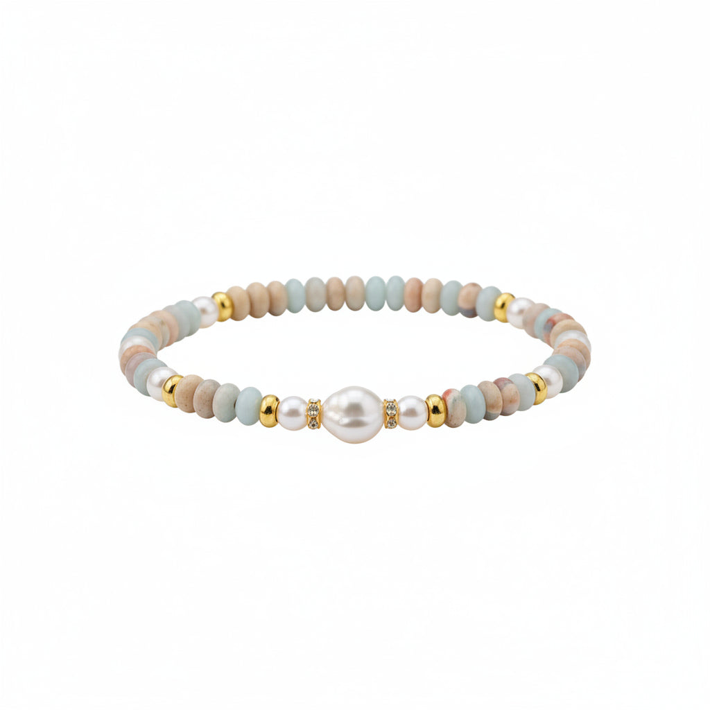 Close-up of a wrist wearing a beaded bracelet with pearls and gold accents.
