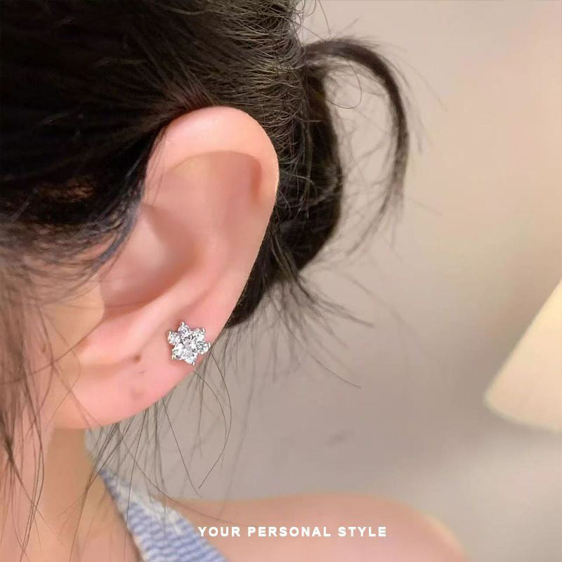 Close-up of an ear wearing a diamond 