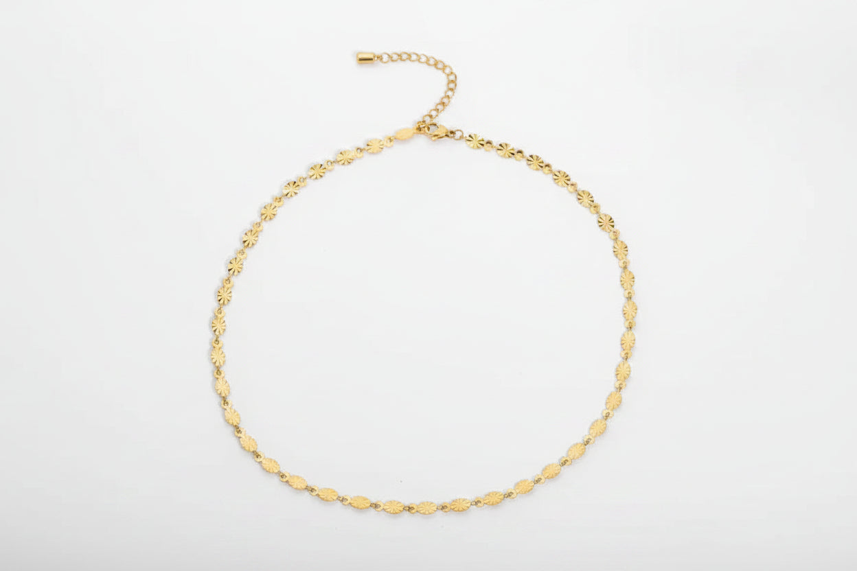 Gold anklet with chain on a white background