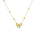 Gold bow-shaped pendant necklace on a white background