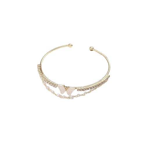 Gold bracelet with a butterfly charm on a white background