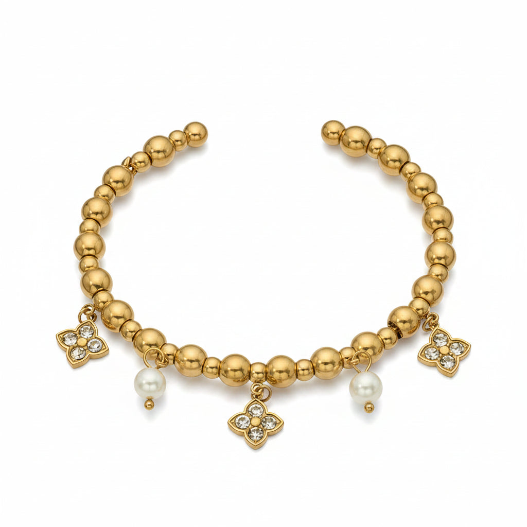 Gold bracelet with charms and measurements on a white background