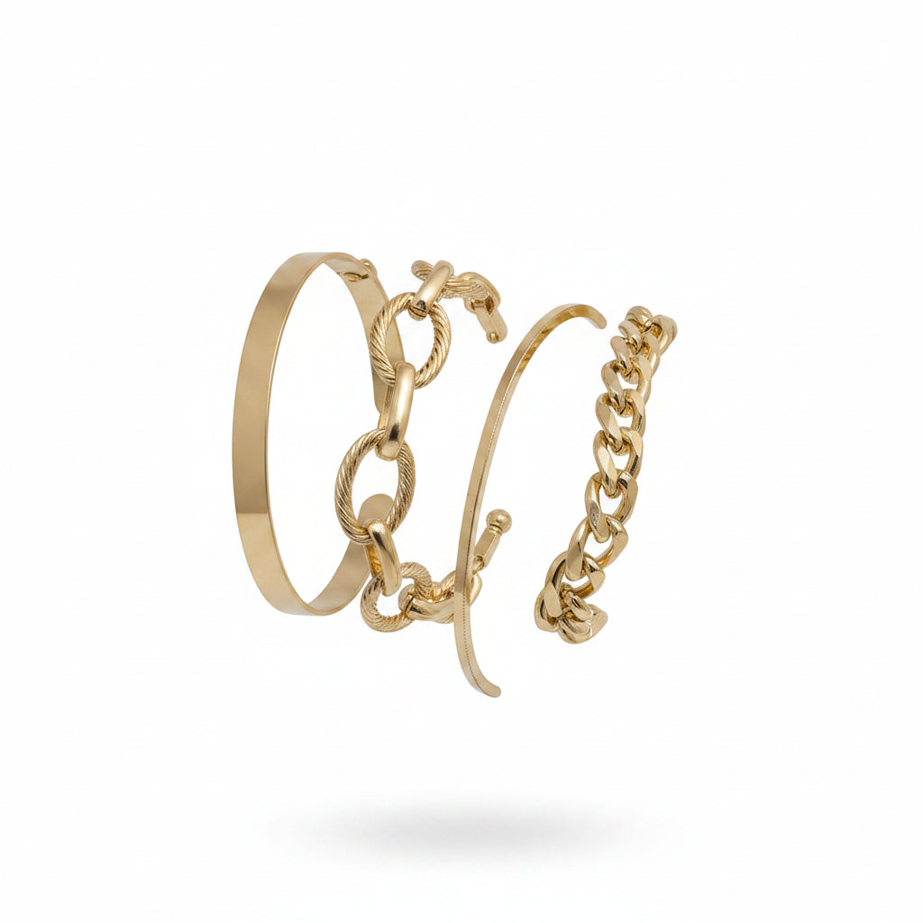 Gold bracelets on a wrist against a neutral background