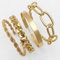 Gold bracelets on a wrist against a white background