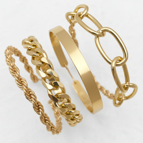 Gold bracelets on a wrist against a white background