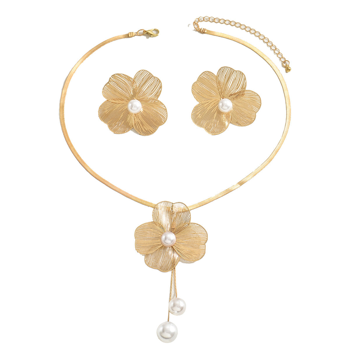 Gold floral jewelry set with pearls on a white background