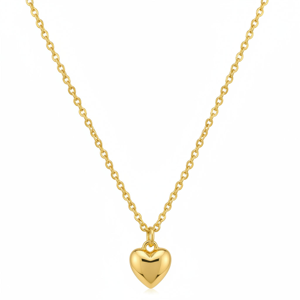Gold heart-shaped pendant necklace on a beige background