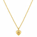 Gold heart-shaped pendant necklace on a beige background