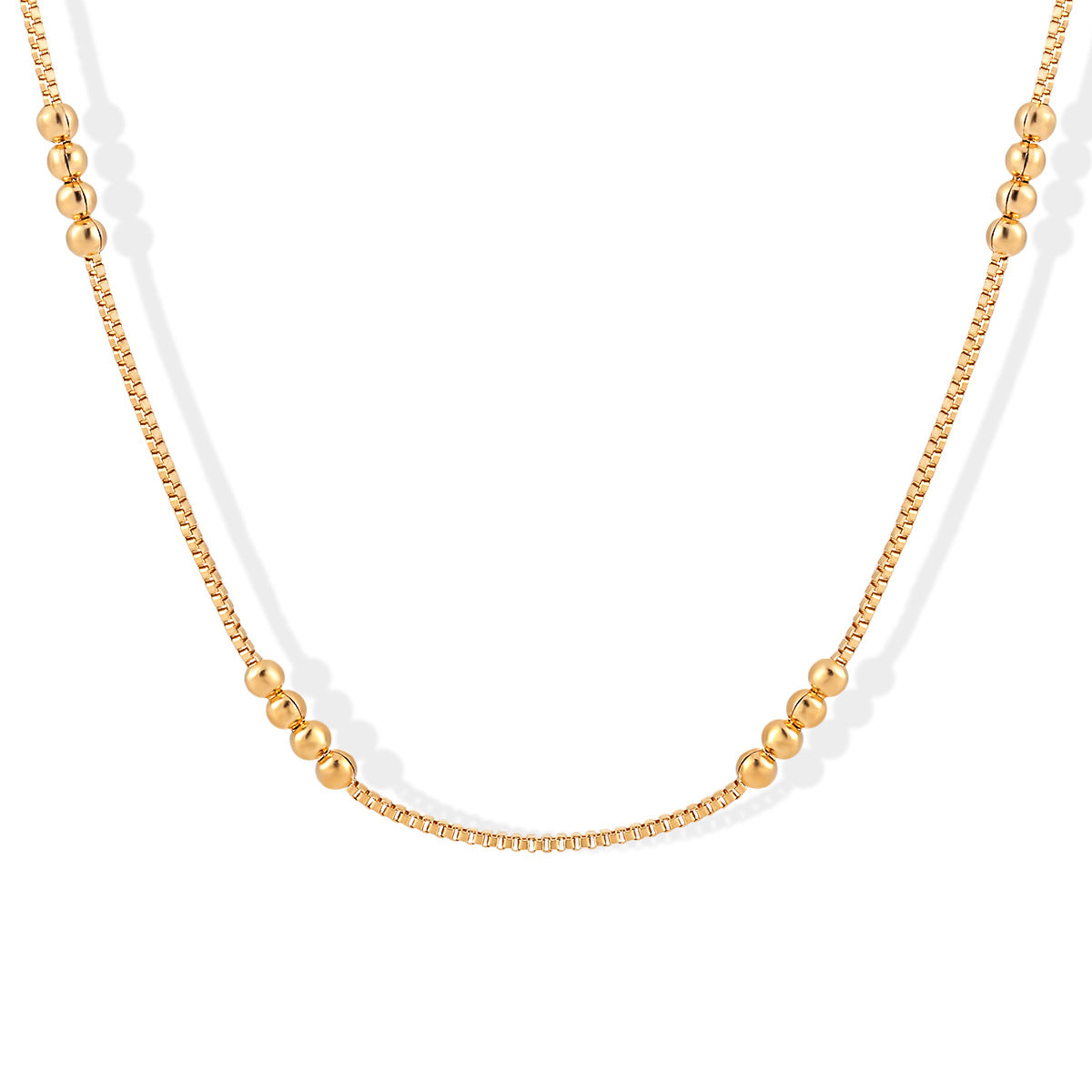 Gold necklace with two different chain styles on a white background