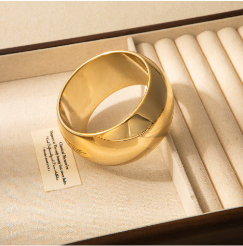 Gold ring in a jewelry box with a label