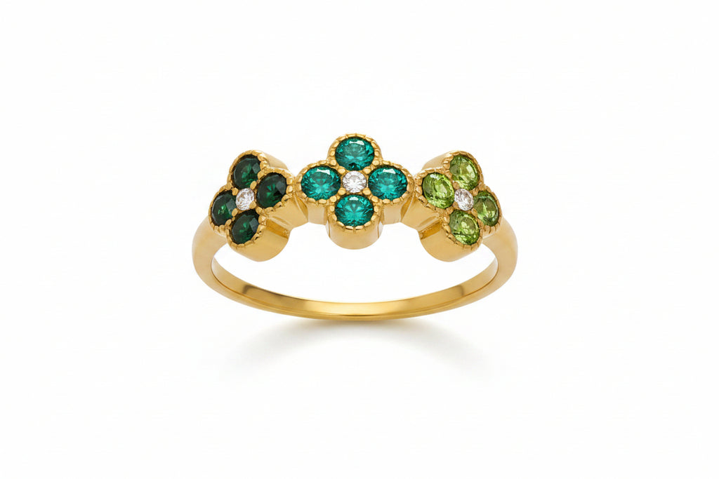 Gold ring with green gemstones and measurements on a white background