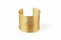 Golden wire bracelet on a light surface