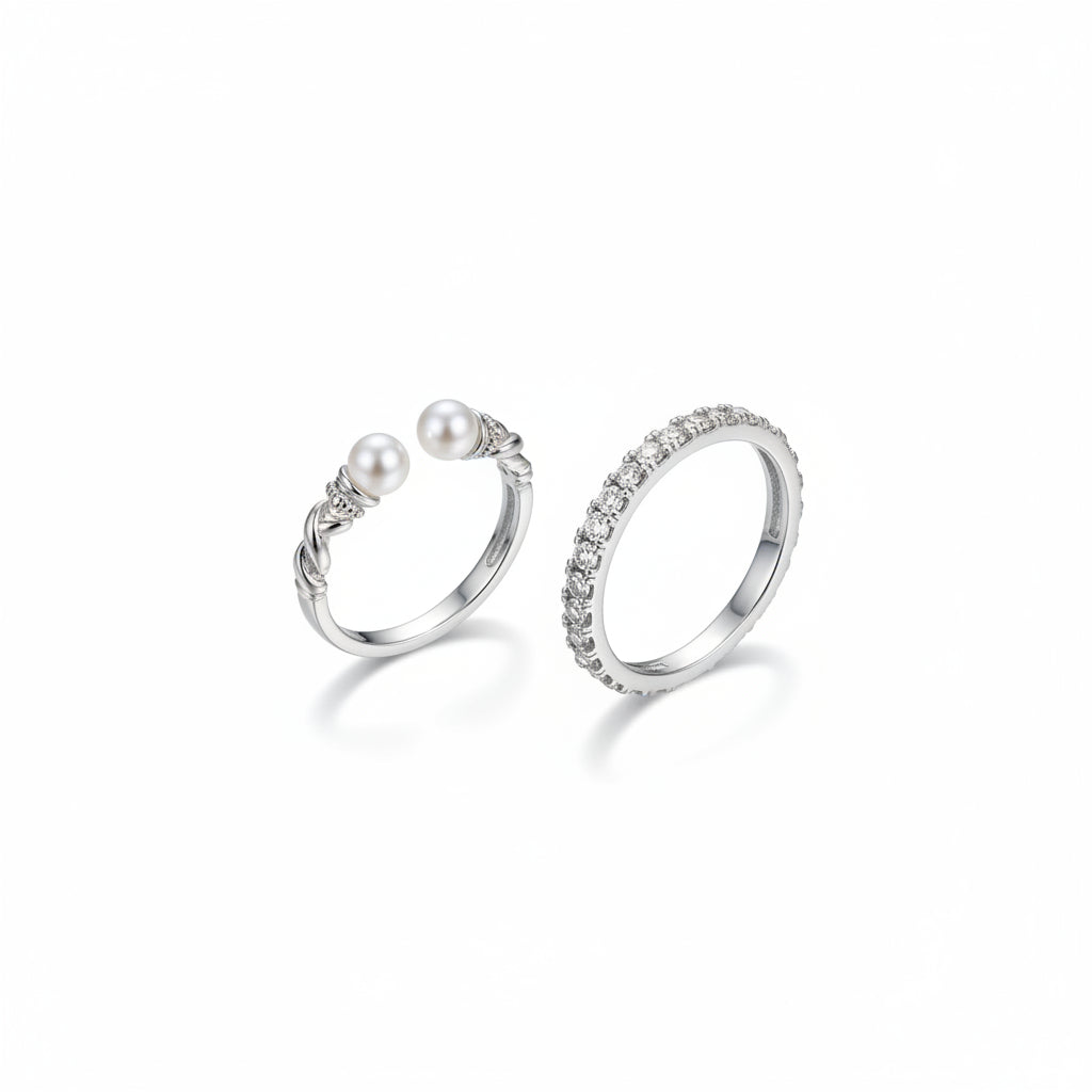 Hand wearing two rings with a blurred background