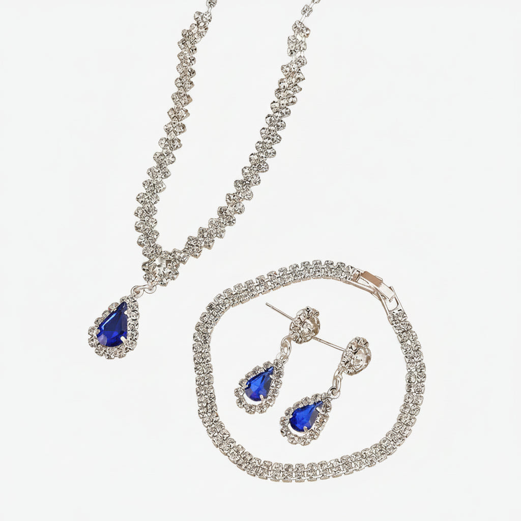 Jewelry set with necklace, earrings, and bracelet on a beige background