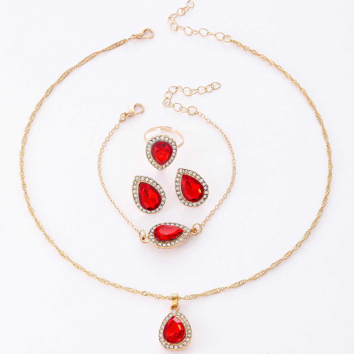 Jewelry set with red teardrop-shaped stones on a white background