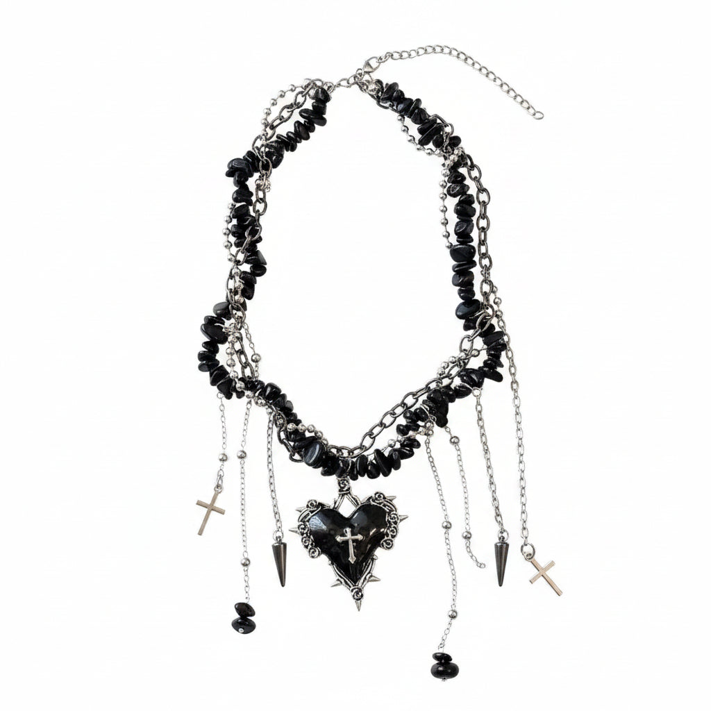 Necklace with black heart pendant and charms on a textured surface with 'Redstar' branding in the background.