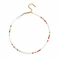 Necklace with colorful beads on a beige background