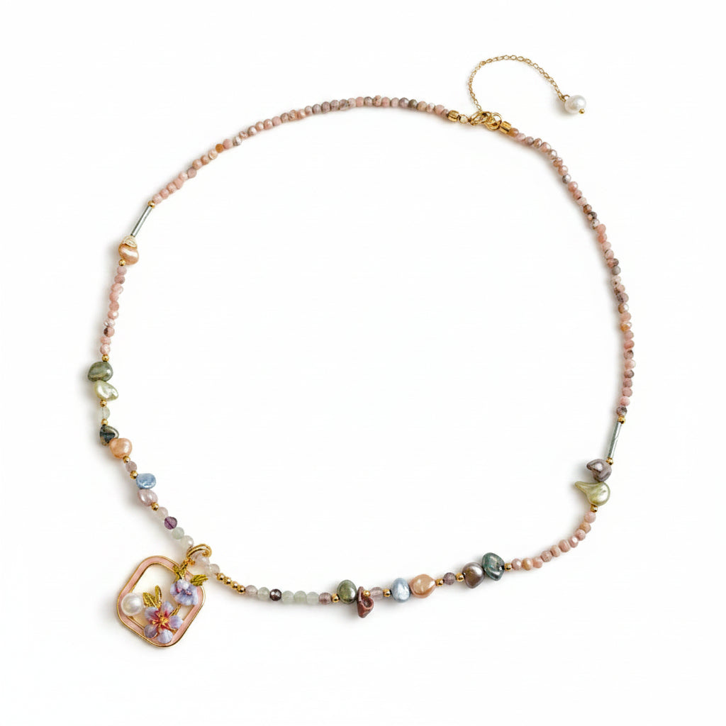 Necklace with multicolored beads and a decorative clasp on a light background