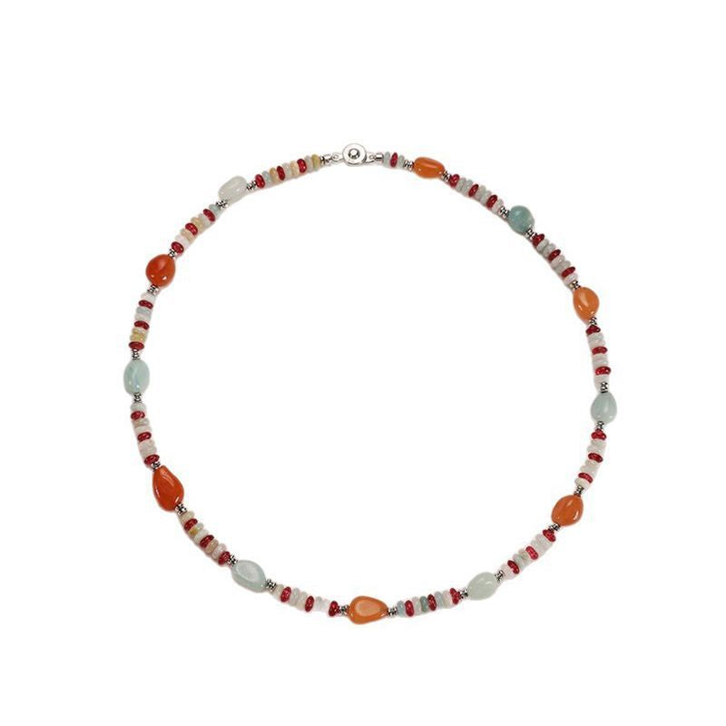 Necklace with orange, white, and red beads on a white background