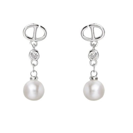 Pearl earrings with silver hooks and clear gemstones on a white background