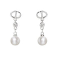 Pearl earrings with silver hooks and clear gemstones on a white background