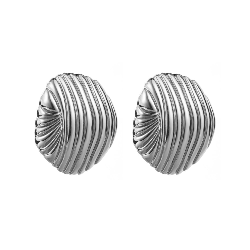 Pair of silver textured round earrings on a white background