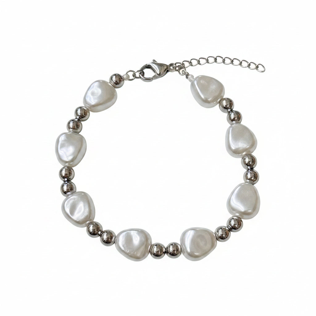 Pearl bracelet with silver beads on a white surface