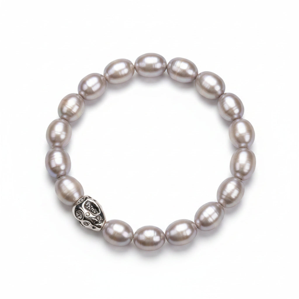 Pearl bracelet with a silver clasp on a beige background