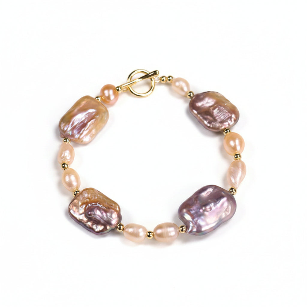 Pearl bracelet with gold accents on a beige background