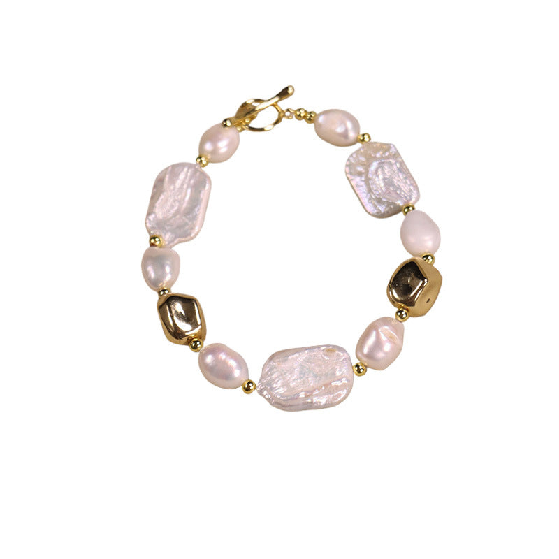 Pearl bracelet with gold accents on a white background