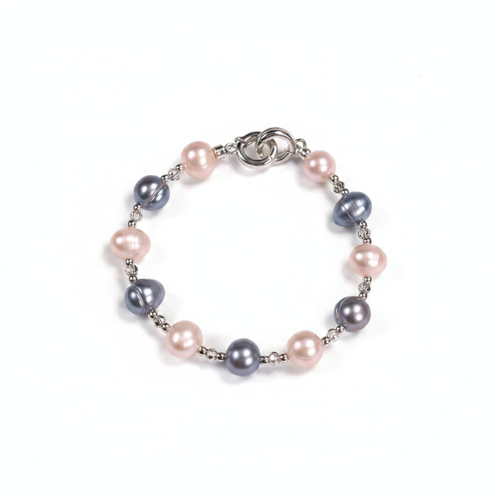 Pearl bracelet with pink and blue pearls on a beige background