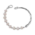 Pearl bracelet with silver clasp on a white background