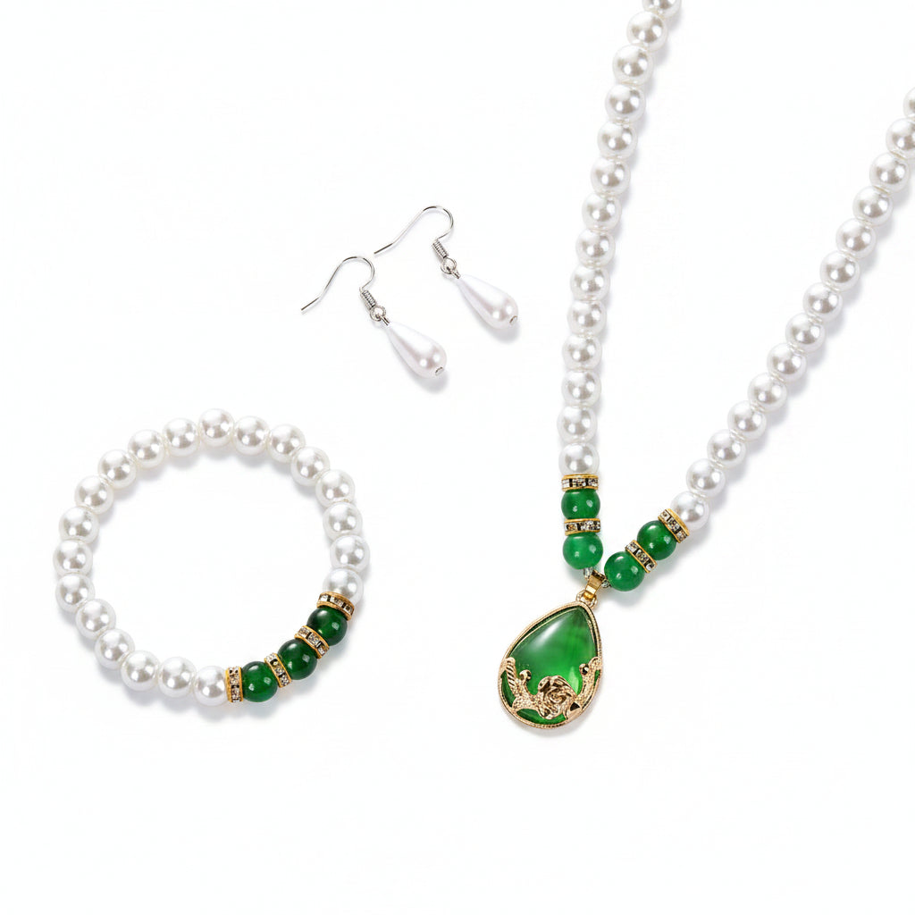 Pearl jewelry set with green accents on a beige surface