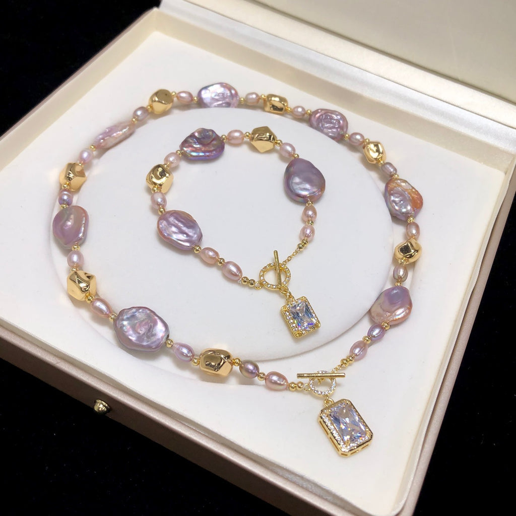 Pearl necklace with gold accents on a white box