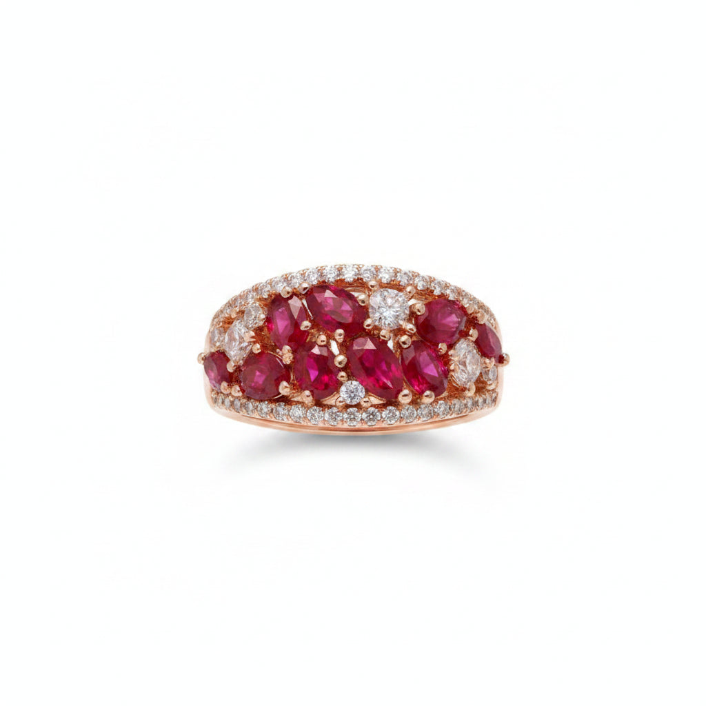 Ring with red gemstones on a finger against a neutral background