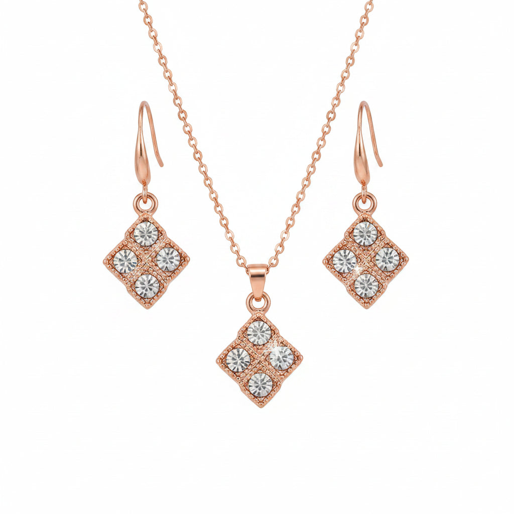 Rose gold necklace and earrings with diamond-like stones on a black background
