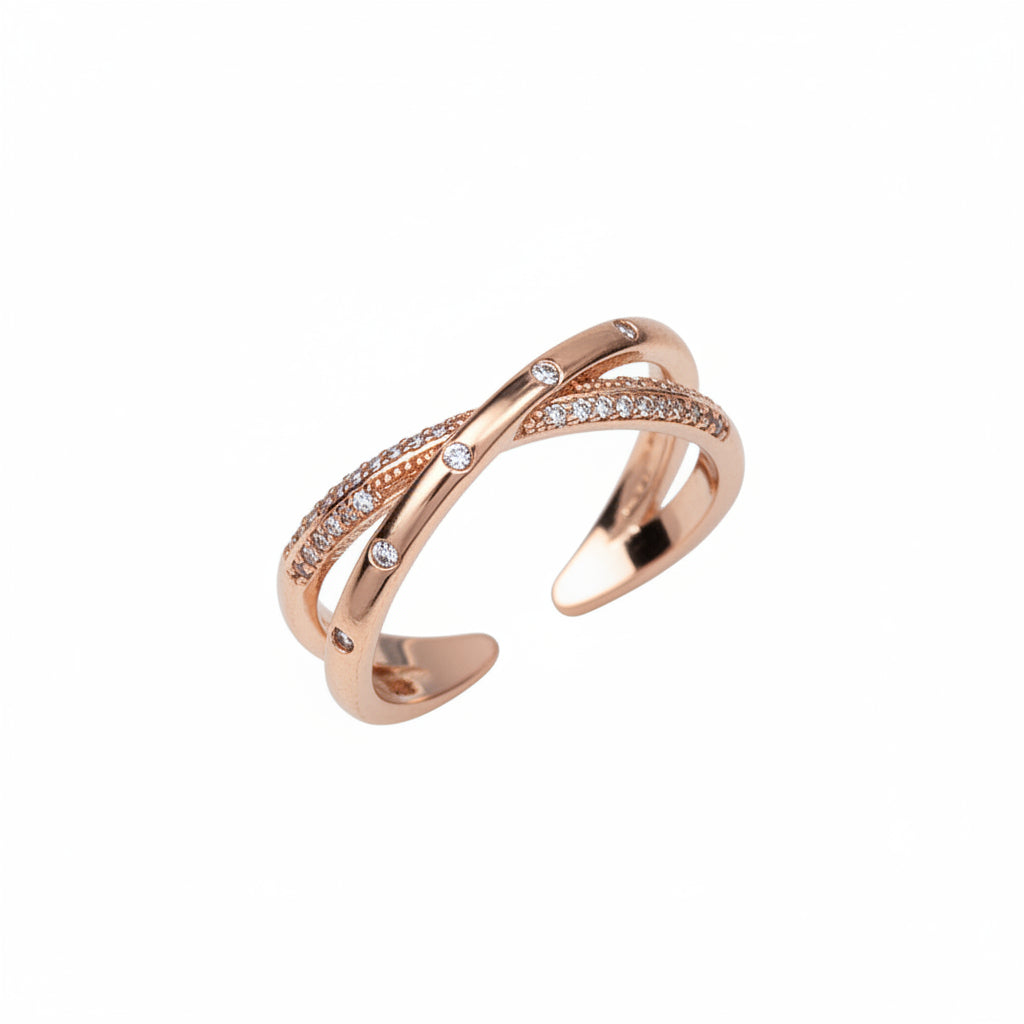 Rose gold open ring with diamond accents on a beige background
