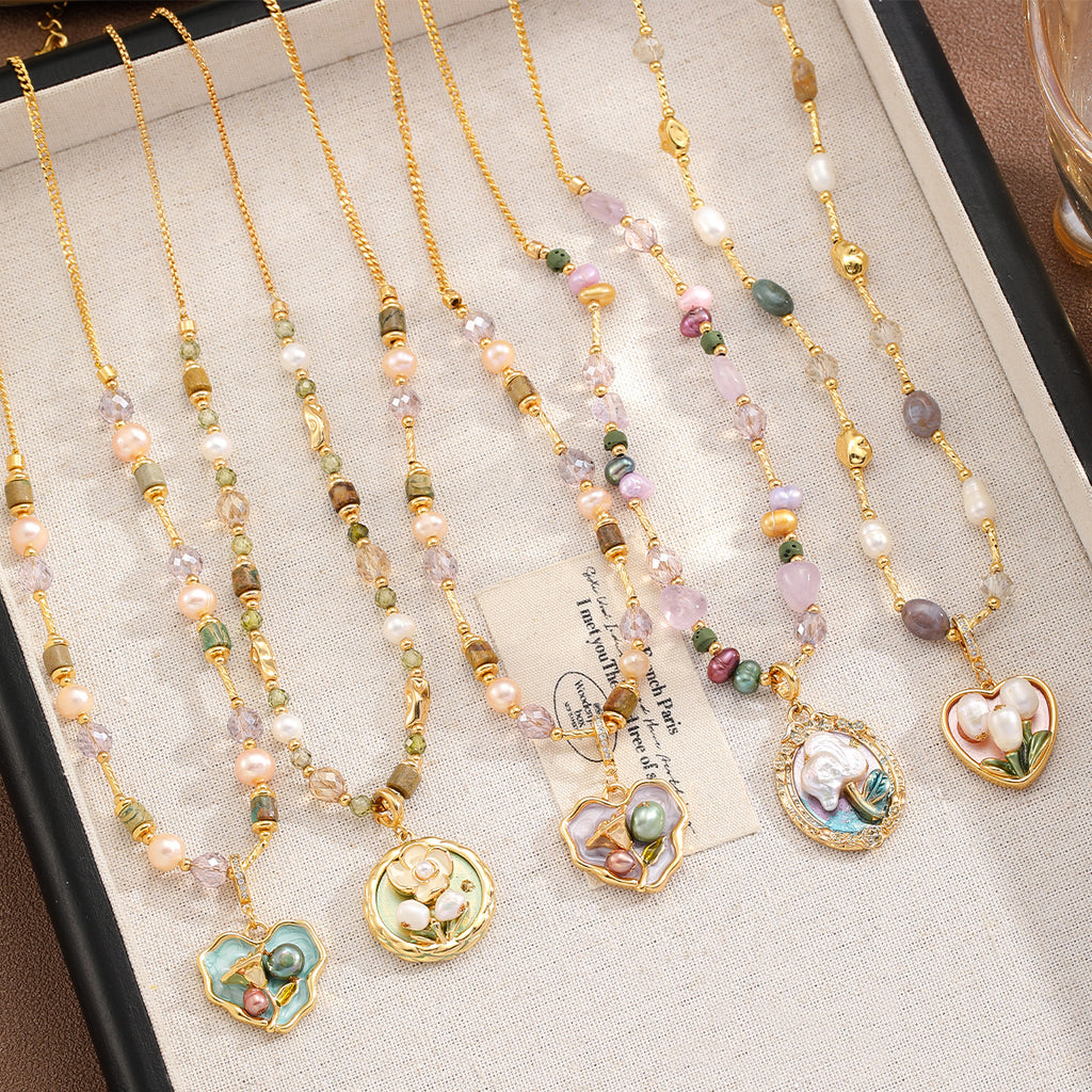 Set of beaded necklaces with floral pendants on a textured surface